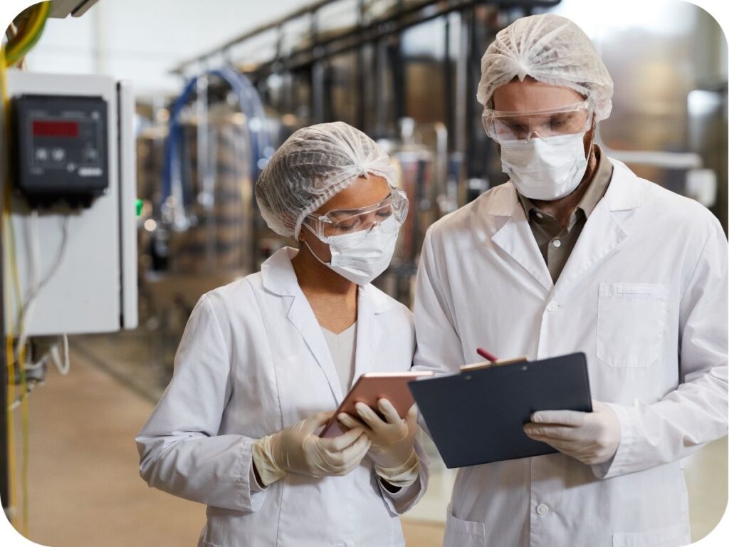 Pharmaceutical technicians preparing herbal supplements for packaging and export